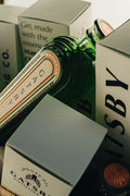 Gatsby Gin bottle emerging from its gift box, close-up