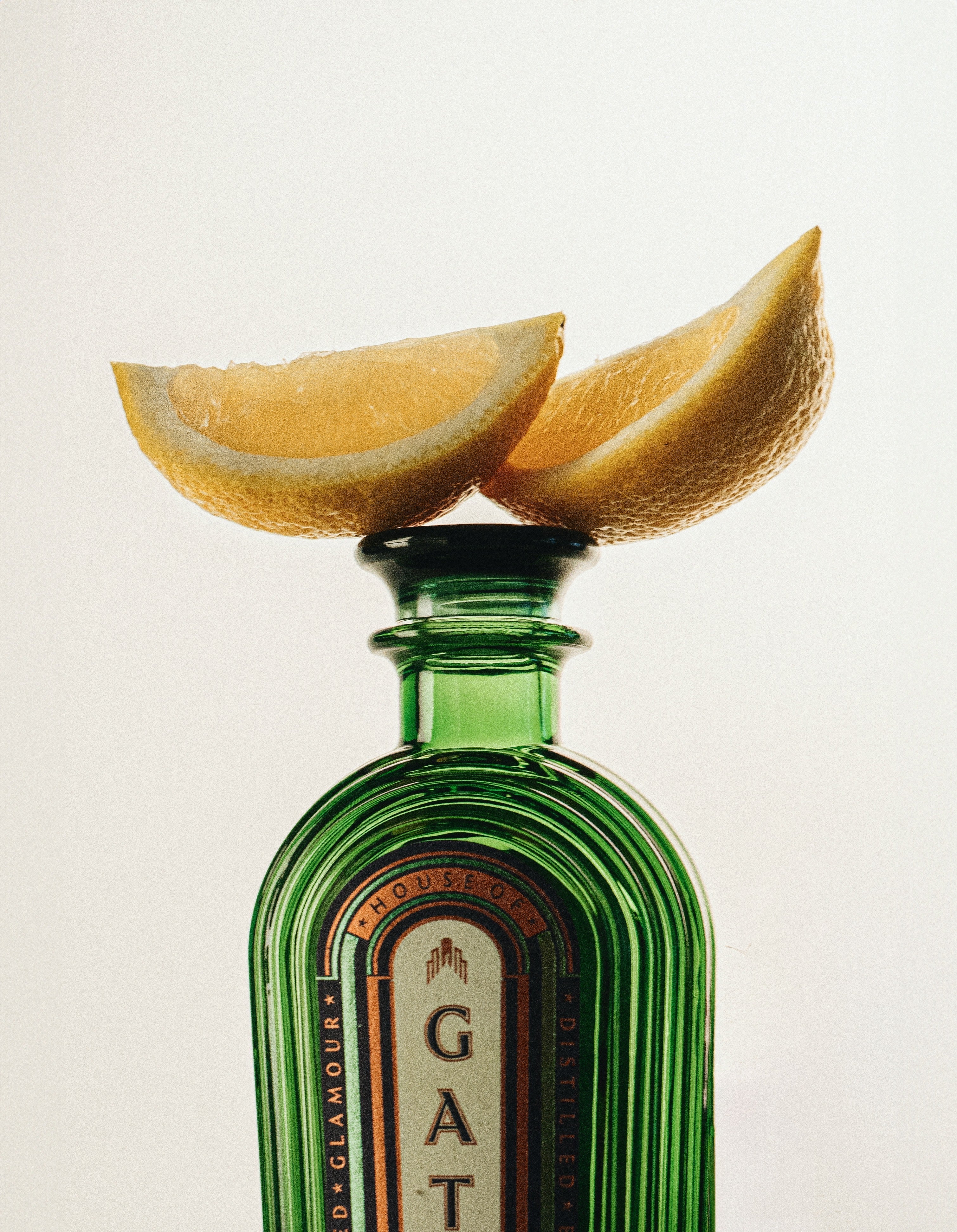 Close-up of lemon wedges resting on the Gatsby Gin bottle stopper